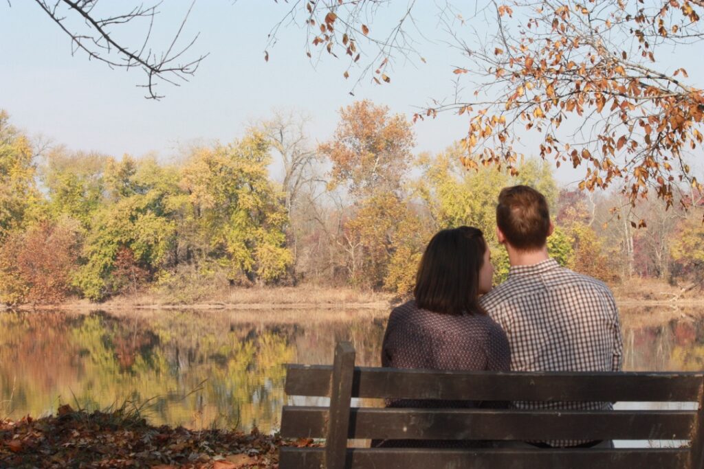 Couple sitting River Side, under a tree