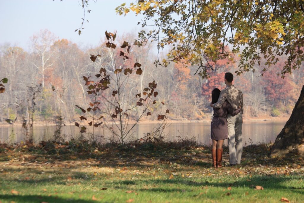 Couple sitting River Side, under a tree